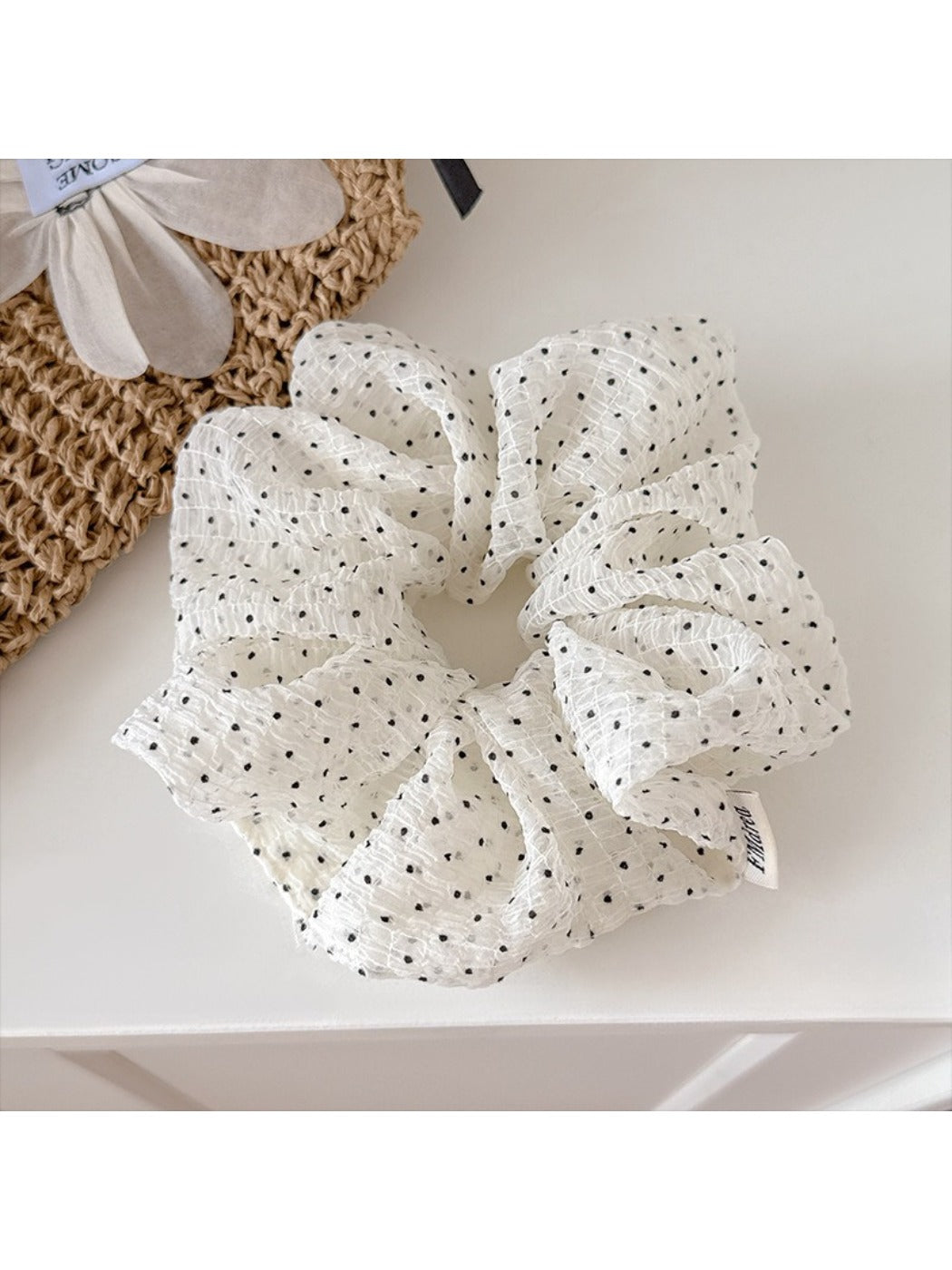 Gifty polka dot tulle scrunchie styled on a wrist as an accessory