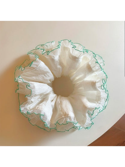 Gifty white tulle double scrunchie with green trim styled in hair