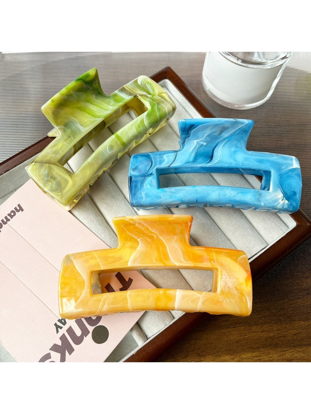 Side view of Beau marble pattern square claw clip showing clip mechanism