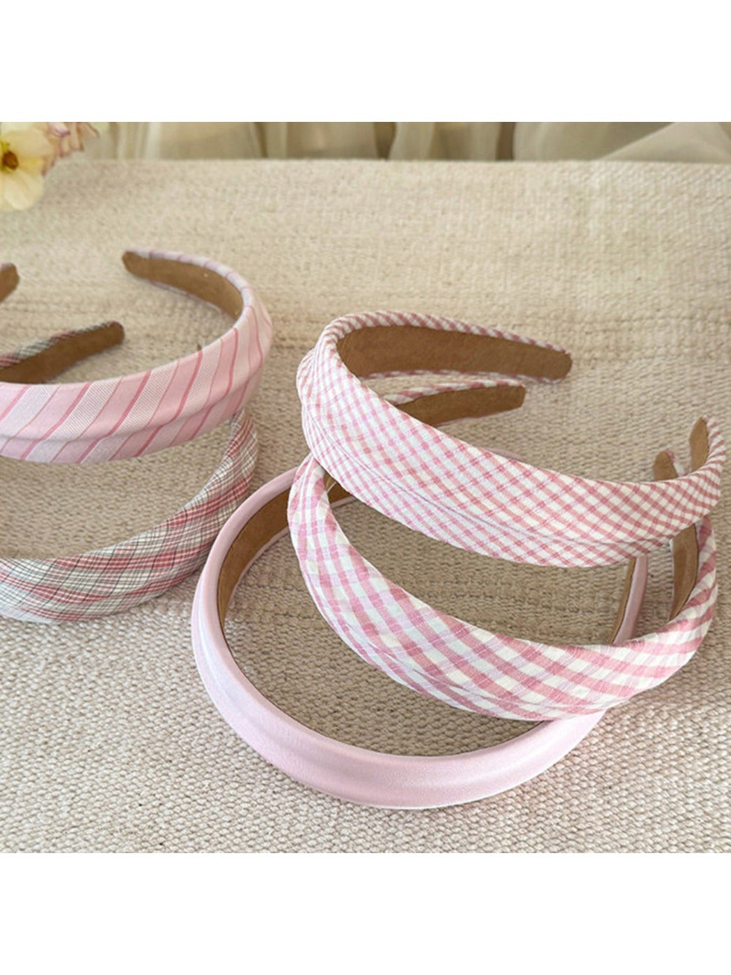Gifty headband styled on mannequin with beige plaid and stripe design
