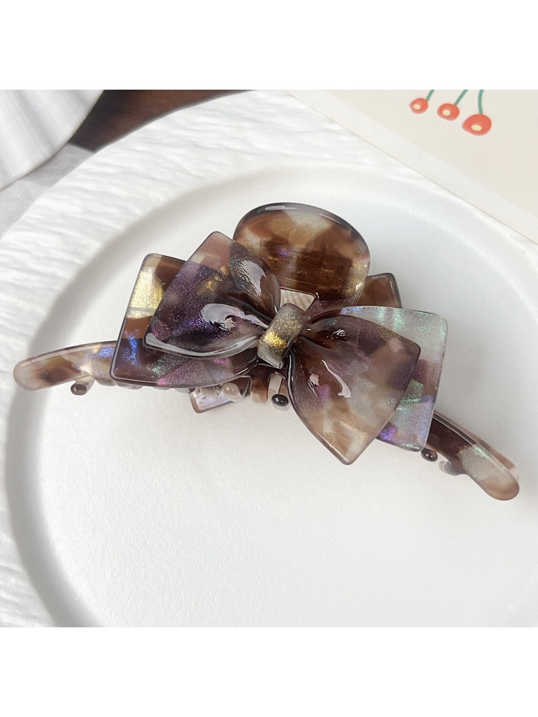 Beau double layer bow hair claw clip displayed with packaging on white surface