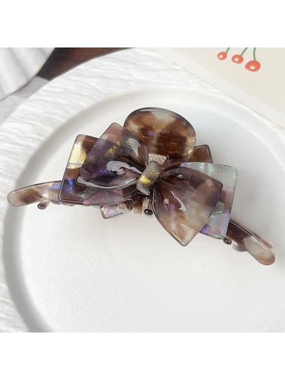 Beau double layer bow hair claw clip displayed with packaging on white surface