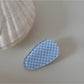 Beau hair clip held in hand showing size and detailed craftsmanship