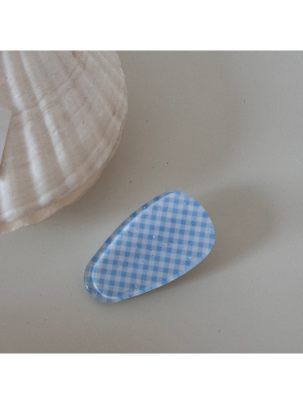 Beau hair clip held in hand showing size and detailed craftsmanship