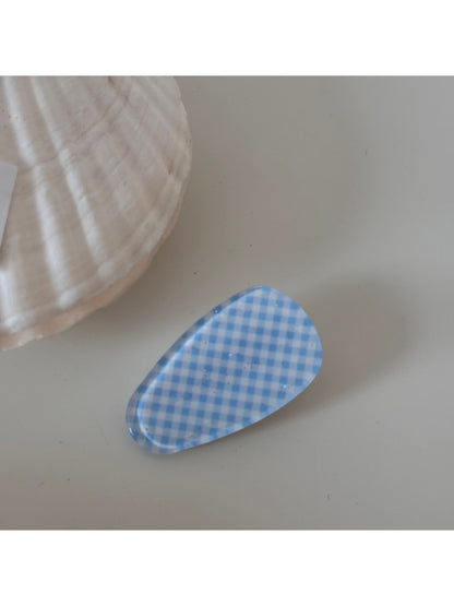 Beau hair clip held in hand showing size and detailed craftsmanship