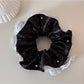 Gifty polka dot scrunchie styled in a ponytail with soft fabric folds visible