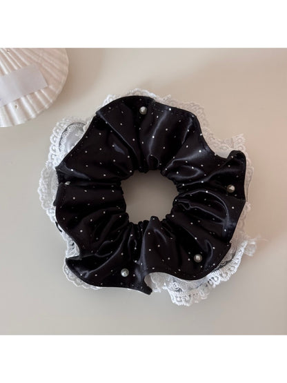 Gifty polka dot scrunchie styled in a ponytail with soft fabric folds visible