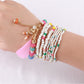 Model wearing multiple Lovra stackable beaded bracelets on wrist with casual outfit