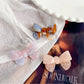 Top view of Beau delicate bow hair clip highlighting the bow shape and fabric folds