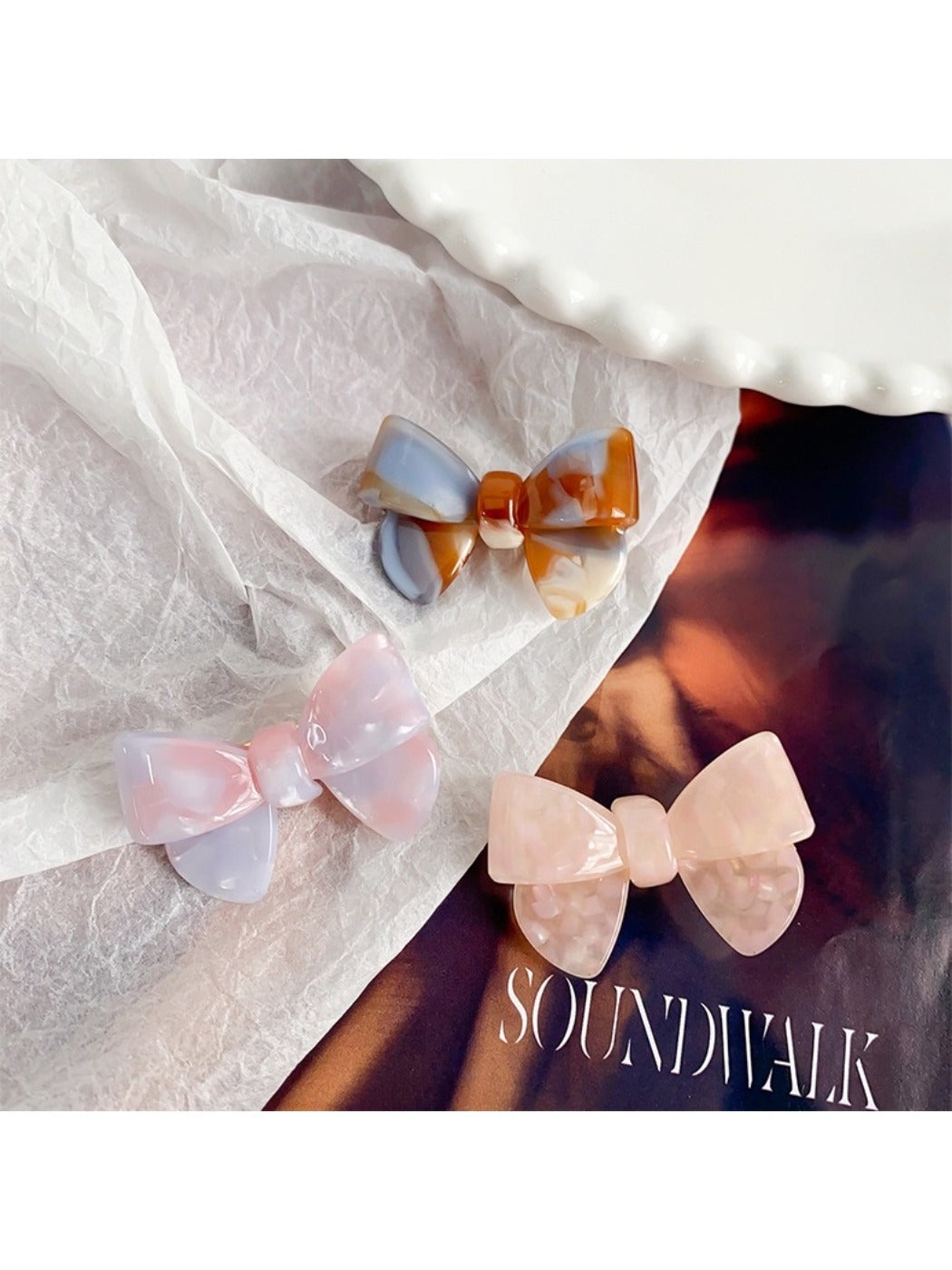 Top view of Beau delicate bow hair clip highlighting the bow shape and fabric folds