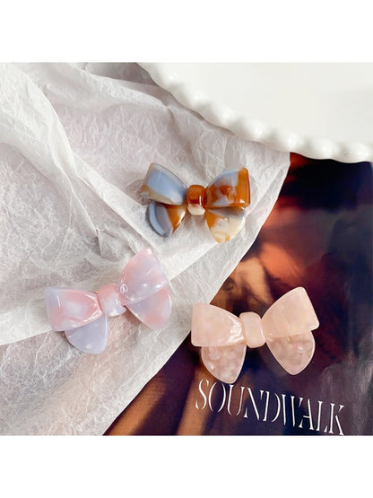 Top view of Beau delicate bow hair clip highlighting the bow shape and fabric folds