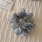 Floral scrunchie styled with casual outfit on model
