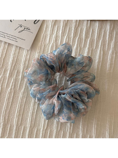 Floral scrunchie styled with casual outfit on model