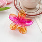 Beau flower claw clip with glossy finish and vibrant multicolor petals