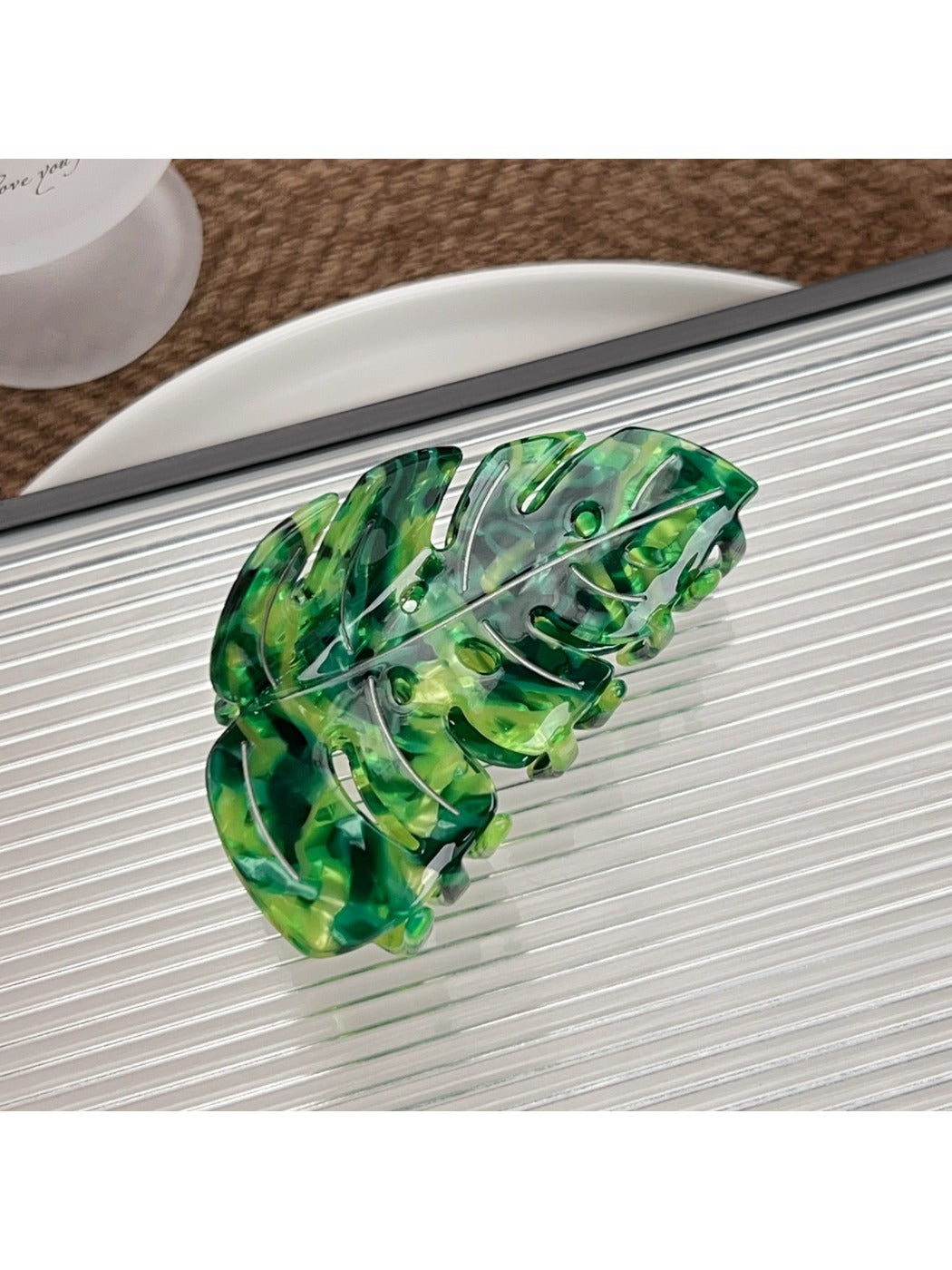 Side view of Beau delicate leaf shaped hair claw clip with metal spring mechanism
