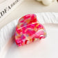 Beau multicolored half moon claw clip displayed with soft lighting