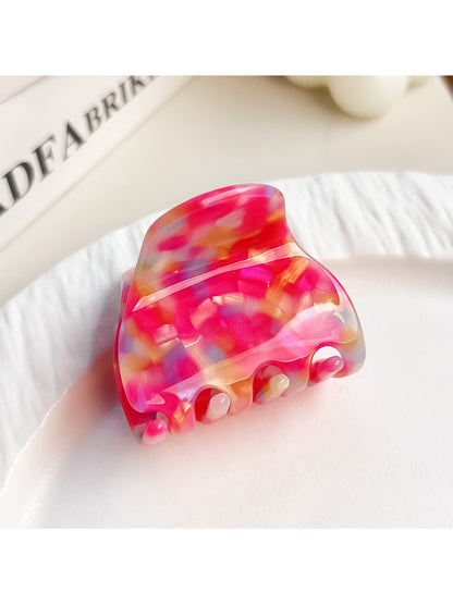 Beau multicolored half moon claw clip displayed with soft lighting