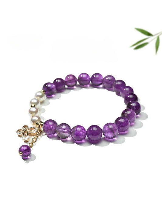 Close-up of Lovra vintage butterfly beaded bracelet with colorful beads and butterfly charm