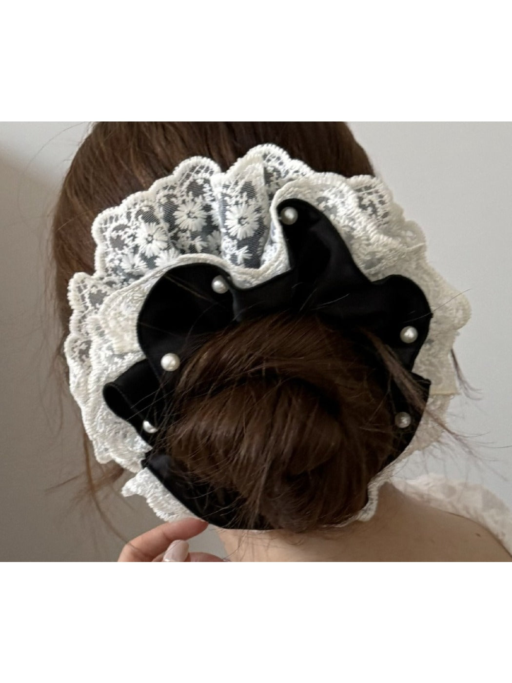 Close-up of beige lace trim detail on satin scrunchie