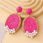 Model wearing Earedge raffia woven oval shape earrings with casual outfit