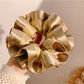Gifty satin ruffle scrunchie styled with casual outfit on a wooden table