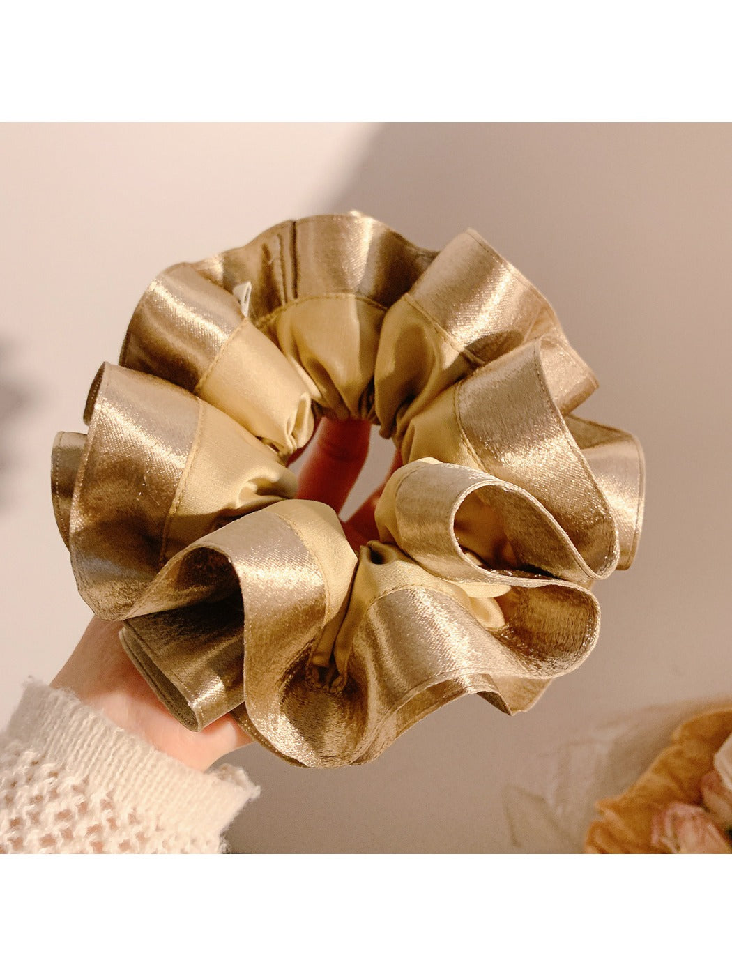 Gifty satin ruffle scrunchie styled with casual outfit on a wooden table