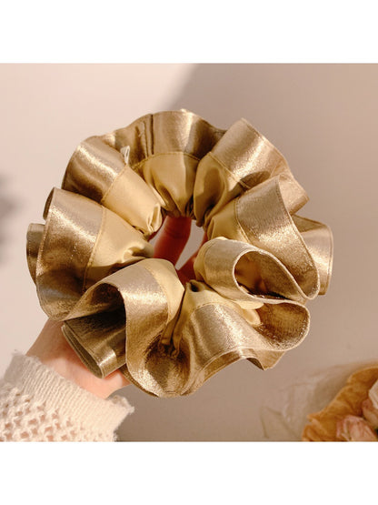 Gifty satin ruffle scrunchie styled with casual outfit on a wooden table