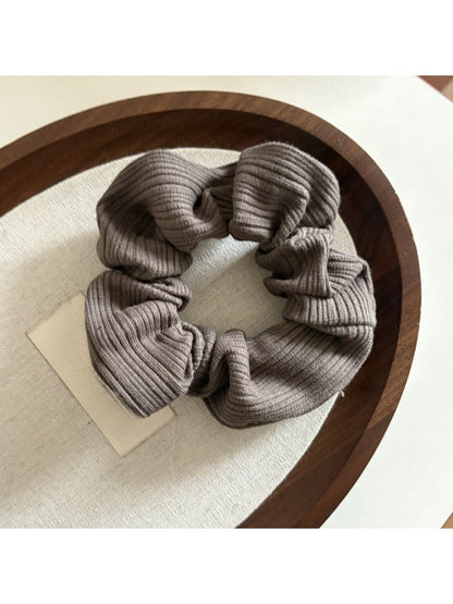 Gifty scrunchie in natural light emphasizing neutral color stripes