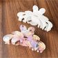 Side view of Beau sweet chic flower claw clip highlighting clip mechanism