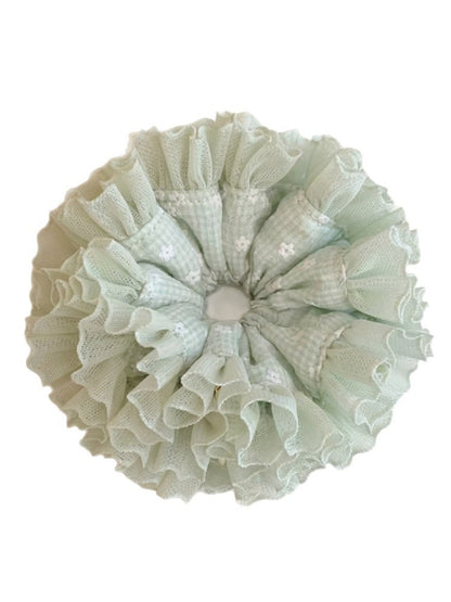 Scrunchie stretched to show elastic band inside mint green plaid tulle ruffles