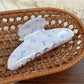 Beau blue floral hair claw clip angled to show glossy finish and pattern