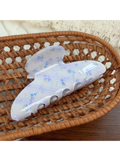 Beau blue floral hair claw clip angled to show glossy finish and pattern