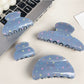 Close-up of blue star pattern on Beau hair claw clip
