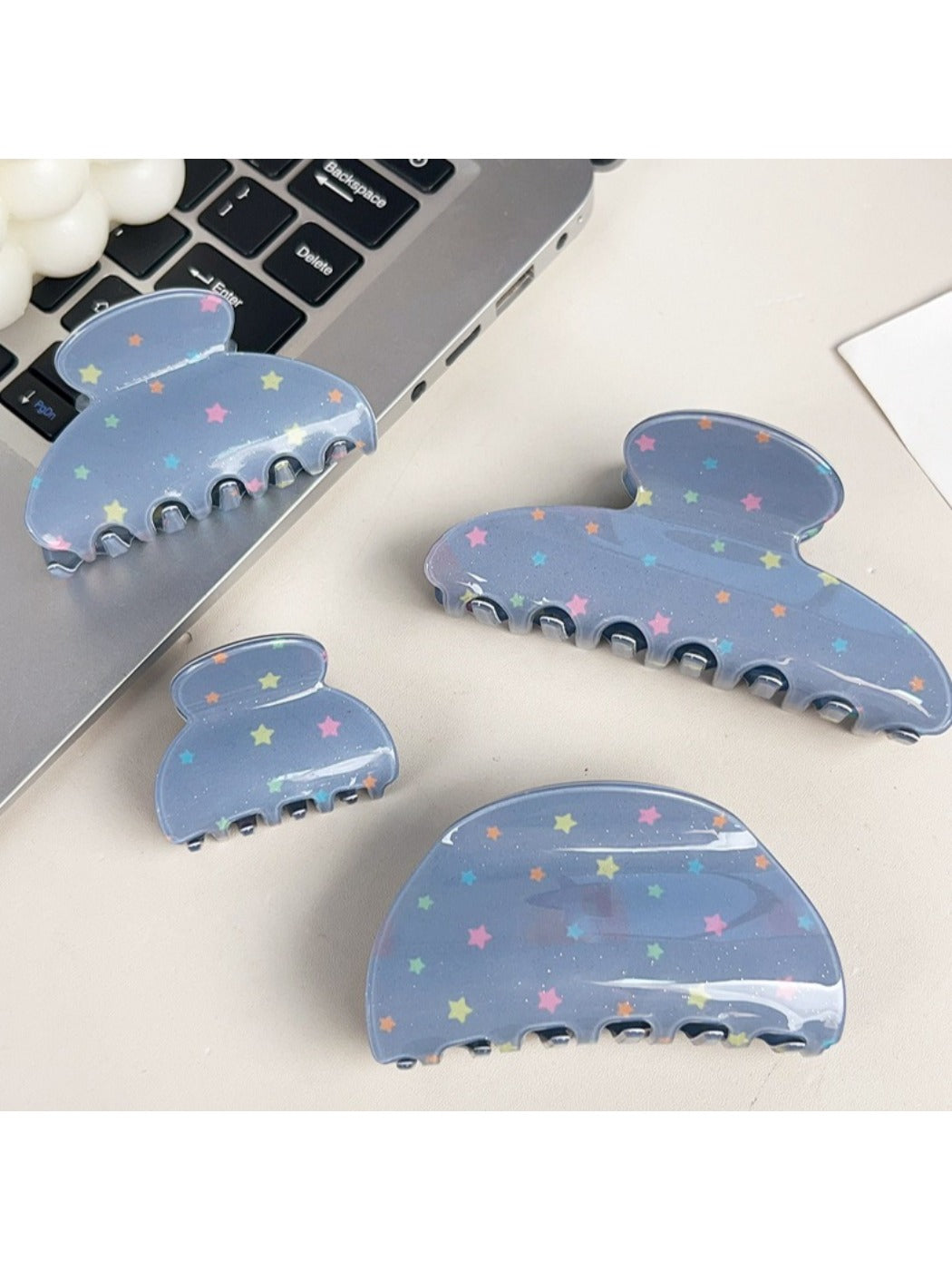 Close-up of blue star pattern on Beau hair claw clip