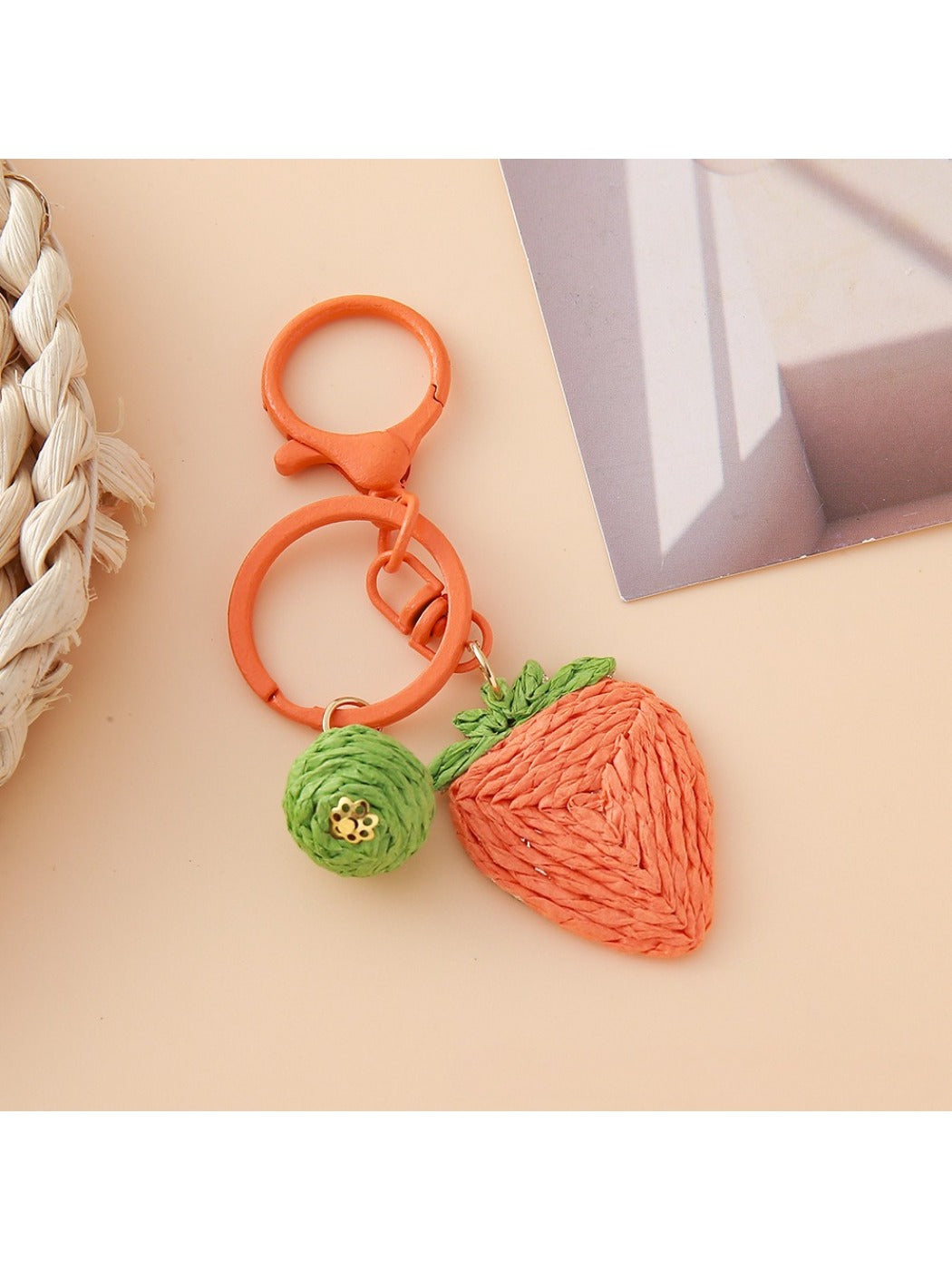 Top view of the strawberry charm keychain highlighting the green leaf details