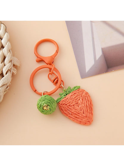 Top view of the strawberry charm keychain highlighting the green leaf details
