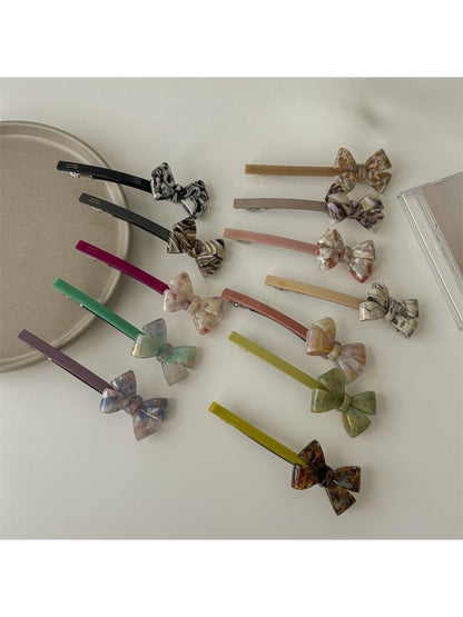 Side view of Beau minimalist bow bar hair clip highlighting curved shape and clasp