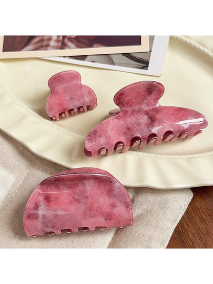 Beau hair claw clip held in hand displaying size and ombre color transition