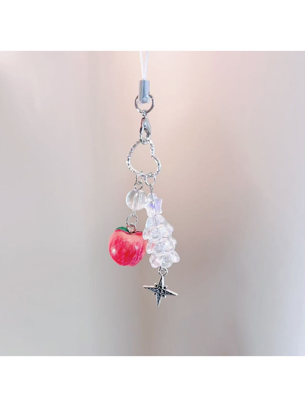 Red apple keychain displayed on a white background highlighting its compact size