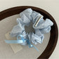 Gifty Sweet Bow Stripe Scrunchie packaged in a clear plastic bag with branding