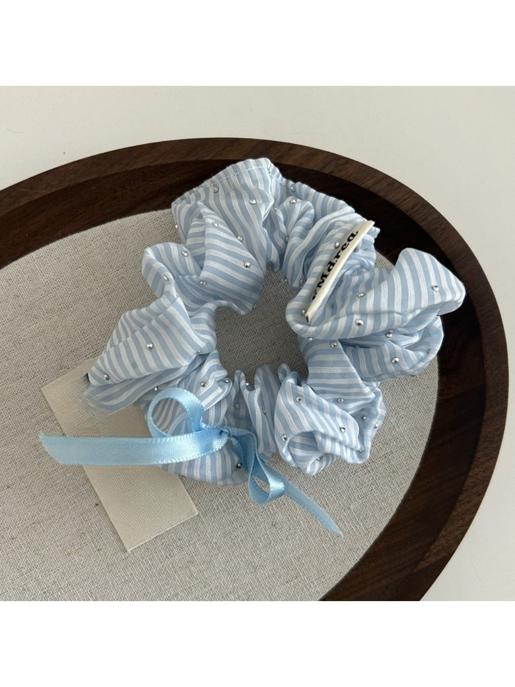 Gifty Sweet Bow Stripe Scrunchie packaged in a clear plastic bag with branding