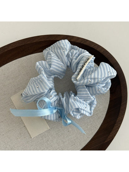Gifty Sweet Bow Stripe Scrunchie packaged in a clear plastic bag with branding
