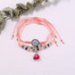 Lovra small bead tassel alloy bracelet styled with casual outfit on wrist