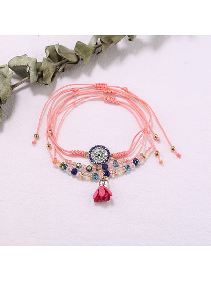 Lovra small bead tassel alloy bracelet styled with casual outfit on wrist
