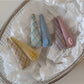 Side view of Beau colorful oval hair clip highlighting its curved shape and clasp