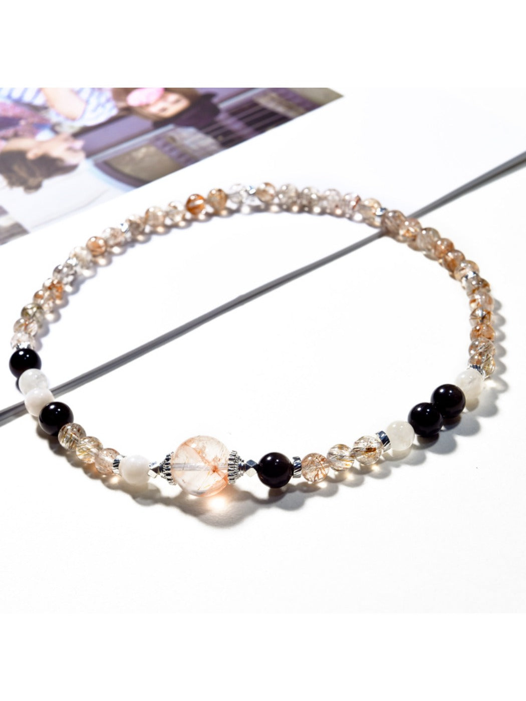 Lovra bracelet wrapped multiple times around a wrist, highlighting black and gold crystals