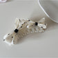 Beau polka dot bow banana clip styled in long hair
