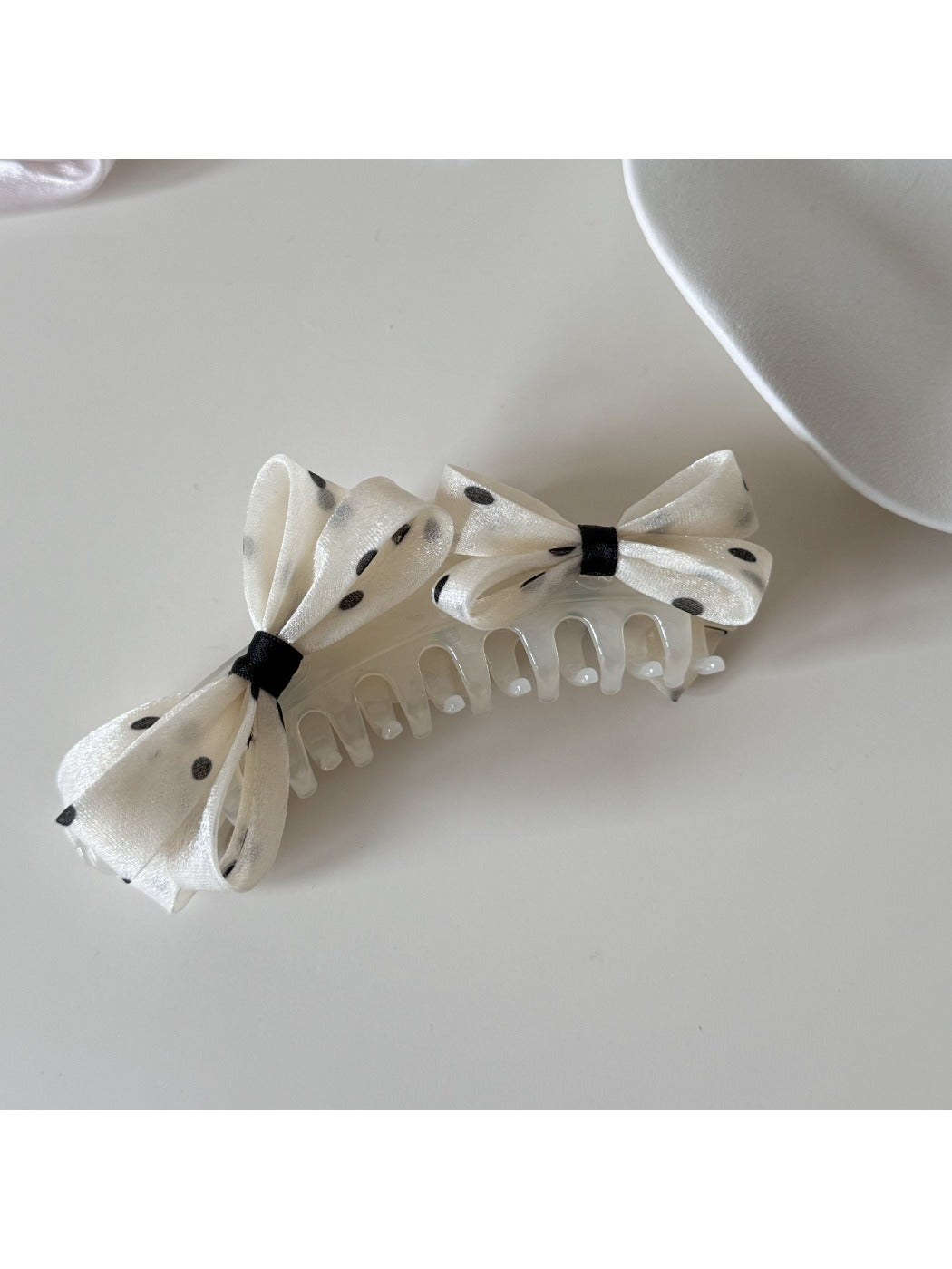 Beau polka dot bow banana clip styled in long hair
