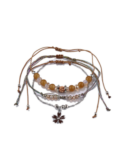 Lovra small bead bracelet styled with other jewelry pieces on wrist