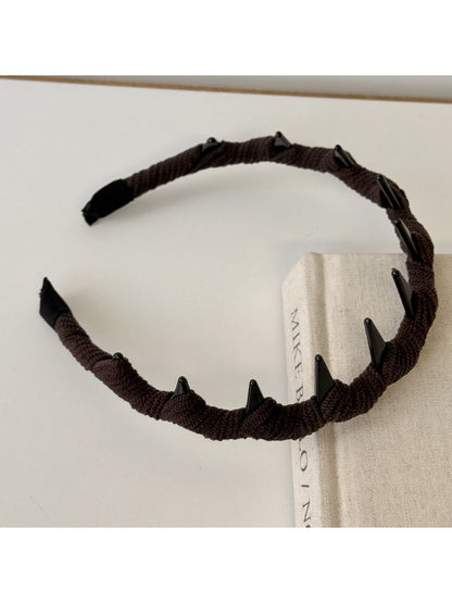 Side view of beige corduroy headband highlighting fabric texture and elastic